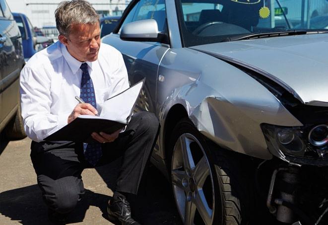 white car with insurance documents on dashboard